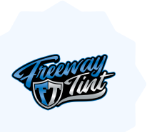 Freeway Tint logo featuring stylized blue and silver script with a shield emblem displaying the initials "FT," set against a light starburst-shaped background.